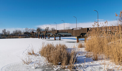 Beautiful old wooden footbridge over the frozen Nogat river in Malbork
