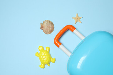 child's travel suitcase, toys, spice cream on a blue background