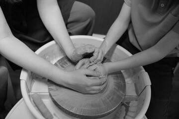 Close-up of hands shaping clay on pottery wheel in studio Creative ceramic art and mindful craft