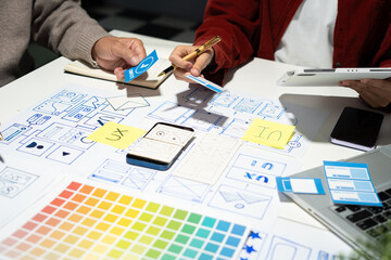 Creative digital development agency. developer team brainstorming on their project with laptop, smartphone and digital tablet.