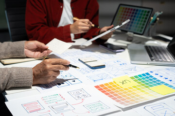 Creative digital development agency. developer team brainstorming on their project with laptop, smartphone and digital tablet.