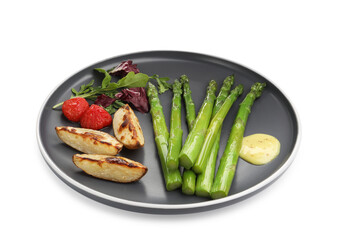 Tasty cooked asparagus with baked potatoes, tomatoes and sauce isolated on white