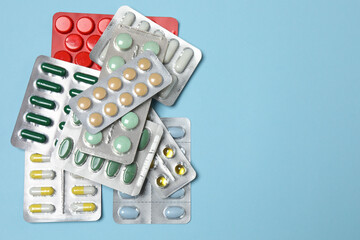 blisters of tablets on a blue background