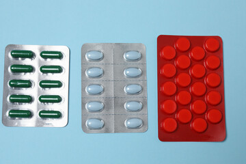 blisters of tablets on a blue background