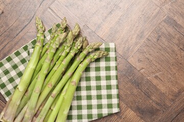 Fresh raw asparagus on wooden table, top view. Space for text