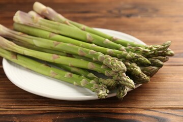 Fresh raw asparagus on wooden table, closeup