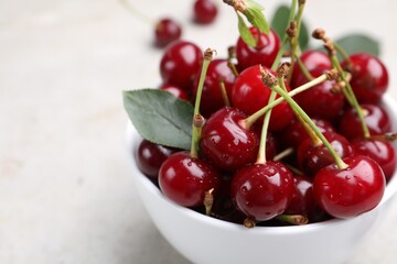Wet ripe cherries on light table, closeup
