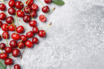 Fresh ripe cherries on light table, flat lay. Space for text