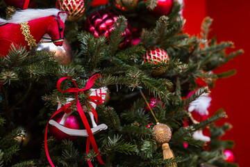 Close-up. Beautiful red horse on a Christmas tree. Beautiful Christmas background. Concept of...