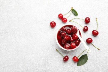 Tasty cherry jam and fresh fruits on light table, flat lay. Space for text