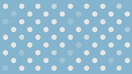 A light blue background with an array of white polka dots and some patterned polka dots scattered around