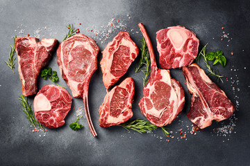 Variety of raw beef meat Prime steaks for grilling with seasoning: Tomahawk steak, Ribeye, T-bone...