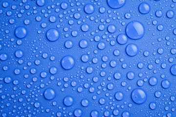 Water drops on an abstract blue background. Macro photo. Top view.
