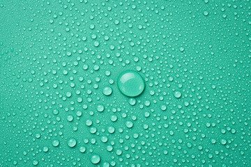 Close up of water drops on a green background. Macro photo. Top view.