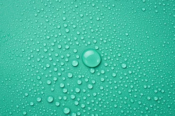 Fotobehang Close up of water drops on a green background. Macro photo. Top view. © Yaruniv-Studio