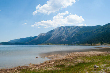 Beautiful nature background featuring the calm waters of Blidinje Lake and its serene environment.

