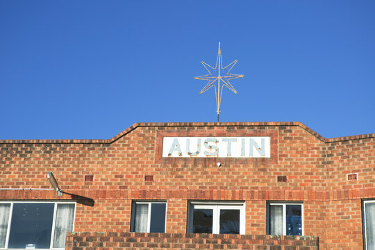 Star and Austin sign on top of old brick unit block