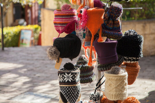 Woolen winter hats for sale on a hat stand