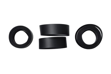 Three black tire-like objects, stacked and arranged
