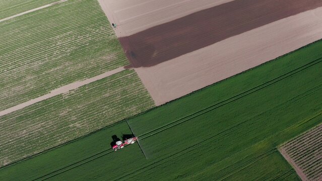 Aerial View of Tractor in Green Farmland
