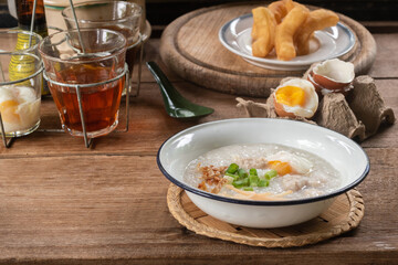 Rice porridge or pork congee for breakfast, boiled eggs, fried dough sticks, traditional coffee,...