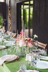 Elegant wedding reception table setting with floral arrangements and candles in a charming venue