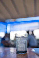 Sphere glass with ice cubes and water on table. Close up