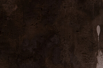 Dark brown texture of a wall. Grainy and rough. Background for projects.