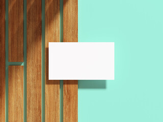 White business card on a wooden surface with flat background.