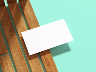 A simple business card on a wooden plank with a cool flat backdrop.