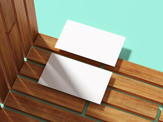 Business card placed on wooden strips with a light background.