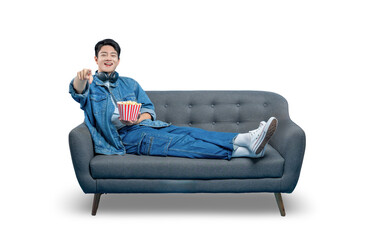 PNG,A young man lounging on a sofa with popcorn points at the camera, as if choosing the viewer or reacting to the screen.

