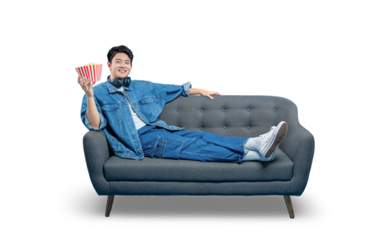 PNG,A friendly young man lounging on a sofa offers a bucket of popcorn, perfect for a welcoming, shared entertainment concept.
