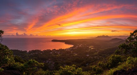 Obraz premium Vibrant Orange Sunset Over Tropical Coastal Landscape