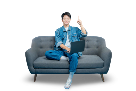 Asian man sitting on a sofa with a laptop raises a finger, as if having a good idea while working or browsing online.PNG