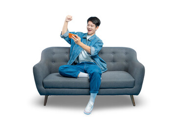 An excited young man celebrates winning a mobile game with a triumphant fist pump while sitting on the couch.PNG