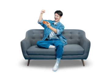 An excited young man celebrates winning a mobile game with a triumphant fist pump while sitting on the couch.PNG
