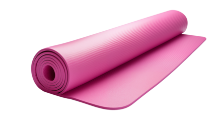 A partially rolled pink yoga mat on a black background in studio lighting