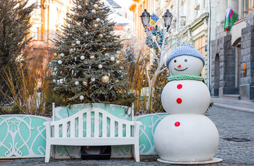 Holiday snowmen on the streets of Moscow. Christmas background with a snowman. Concept of...