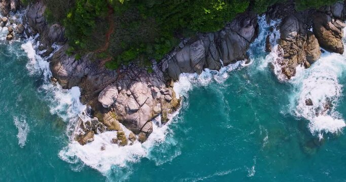 Top down aerial view from above of big waves crashing and foaming on rock stones,Amazing seashore nature background,Wide angle view ocean sea from drone camera 4k High quality footage ProRes 422