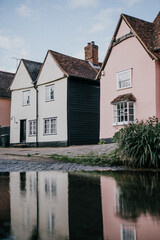 A row of houses with one of them being pink