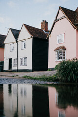 A row of houses with one of them being pink