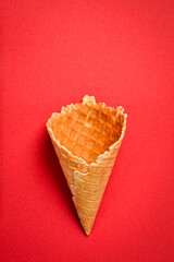 Waffle cup for ice cream on a red background. Top view.