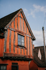 The house is old and has a red and white striped exterior