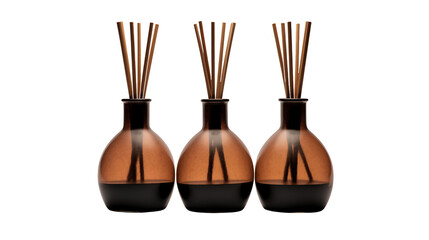 Three aromatic reed diffusers create a calming spa atmosphere with their stylish glass bottles isolated on transparent background