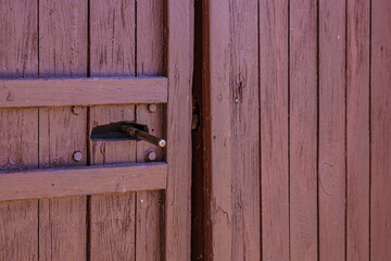 Rustic wooden door with metal latch in close-up view