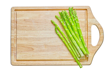 Isolated wooden cutting board with Asparagus on white background. Flat lay design.