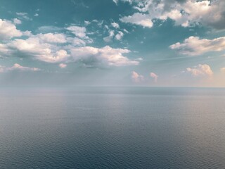 Serene ocean view with soft clouds.