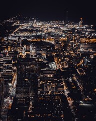 Obraz premium Vibrant cityscape at night with illuminated buildings.