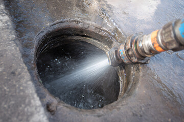 A cut main sewer line being hydro jetted for cleaning